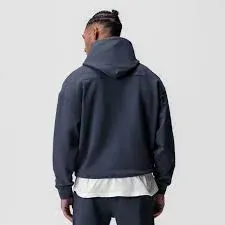 Back view of a man wearing a navy blue custom hoodie and matching pants