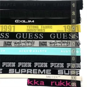 Custom fabric labels with various brand names, logos, and text designs, ideal for adding a personalized touch to apparel and accessories.