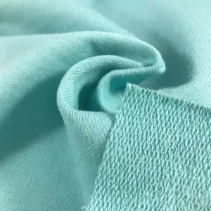 Close-up of light turquoise custom fabric showing knit texture