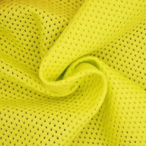 Close-up of neon yellow breathable mesh sports fabric